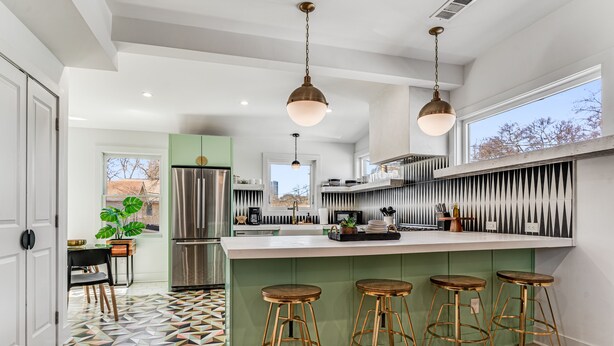 A modern kitchen with a central island, bar stools, and a large window. - Fully Furnished | Fast Wi-Fi | Midterm Stays Welcome (Atlanta)