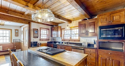 1970s acreage surrounded by trees with deck, grill, & internet