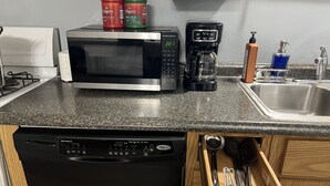 A kitchen with a microwave, coffee maker, and a dishwasher. - Coming into town for any special event.Cozy spacious space with all your needs!  (Mount Pleasant)