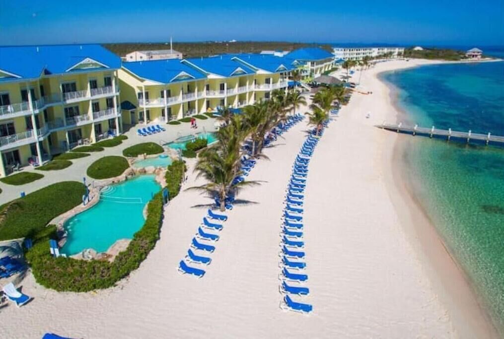 A resort with a pool, beach, and ocean view.