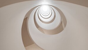 A spiral staircase with a modern design, featuring a central column and ascending steps. - Lumina at Taman Condesa (Mexico City)
