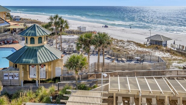 A beachside resort with a pool, beach chairs, and a gazebo. - Modern Luxury, Gulf Views: Renovated 5th-Floor Oasis at Sandestin Golf and Beach Resort! (Miramar Beach)
