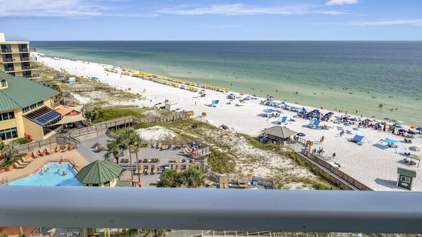 A beach resort with a swimming pool, beach umbrellas, and a lifeguard tower. - "Beachside Serenity: 9th-Floor 1-Bedroom Condo with Gulf Views, Sleeps 4!" at Sandestin Golf and Beach Resort! (Miramar Beach)