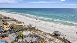 A beach resort with a pool area, beach access, and a lifeguard station. - "Serene Sunrises: Cozy 10th-Floor Haven with Gulf Views in Beachside Two!" at Sandestin Golf and Beach Resort! (Miramar Beach)