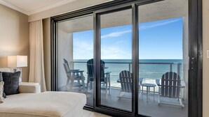 A hotel room with a large sliding glass door leading to a balcony with outdoor seating and a view of the ocean. - "Unrivaled Luxury: Premier 11th-Floor Beachfront Bliss with Gulf Views!" at Sandestin Golf and Beach Resort! (Miramar Beach)
