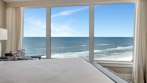 A hotel room with a large window offering a view of the ocean and beach. - "Unrivaled Luxury: Premier 11th-Floor Beachfront Bliss with Gulf Views!" at Sandestin Golf and Beach Resort! (Miramar Beach)