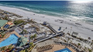 A beach resort with a pool, sun loungers, and a boardwalk leading to the beach. - "Serene Sunrises Await: Inviting 14th-Floor 1-Bedroom Retreat in Beachside Two!" at Sandestin Golf and Beach Resort! (Miramar Beach)