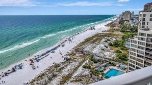 A beachside hotel with a pool, beach umbrellas, and a view of the ocean. - "Beachfront Bliss: 2BR/2BA Condo in Beachside Towers Two with Gulf Views" at Sandestin Golf and Beach Resort! (Miramar Beach)
