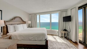 A hotel room with a large bed, a TV, and a view of the ocean. - "Beachfront Bliss: 2BR/2BA Condo in Beachside Towers Two with Gulf Views" at Sandestin Golf and Beach Resort! (Miramar Beach)