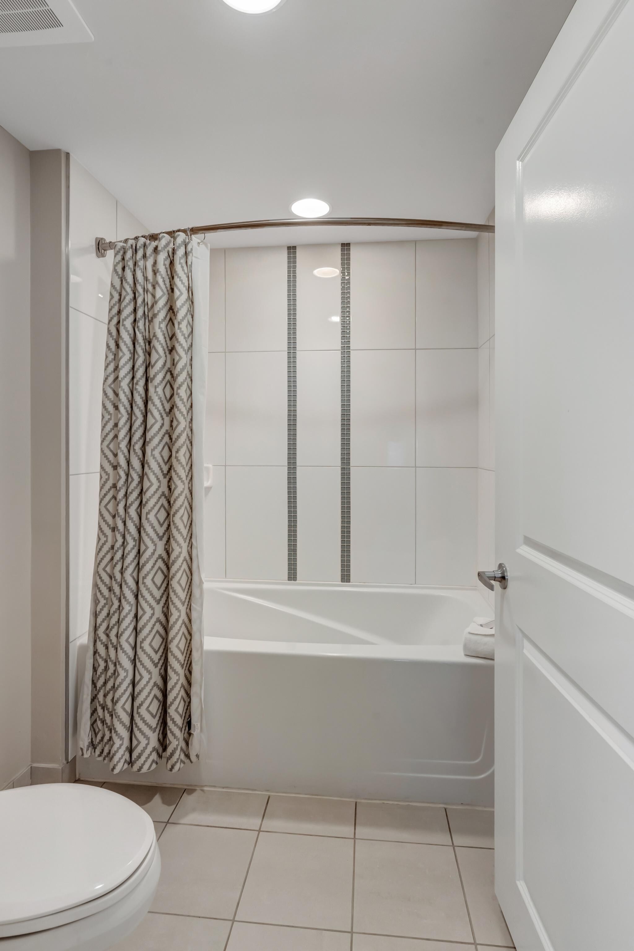 Ein Badezimmer mit Dusche, Toilette und Badewanne.