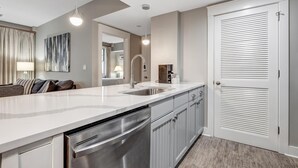 A modern kitchen with a white countertop, stainless steel appliances, and a built-in dishwasher. - Vibrant Village Living - 2-Bedroom Gem with Front-Row Views and Prime Location at Sandestin Golf and Beach Resort! (Miramar Beach)