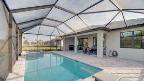 A covered swimming pool with a patio area, outdoor furniture, and a view of the surrounding landscape. - Alva Vacation Rental w/ Pool & Golf Course Access! (Alva)