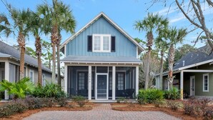 A two-story house with a blue exterior, a front porch, and a garage. - Spacious 3BR/3BA Family Retreat for 8 at Sandestin Golf and Beach Resort! (Miramar Beach)