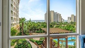 A multi-story hotel with a view of a landscaped area, a pool, and a beach. - King Studio with Gulf Views, Kitchenette, and Sleeper Sofa at Sandestin Golf and Beach Resort! (Miramar Beach)