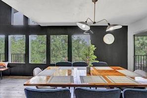 Enjoy meals with friends and family in this spacious dining area, featuring a large table and six chairs.