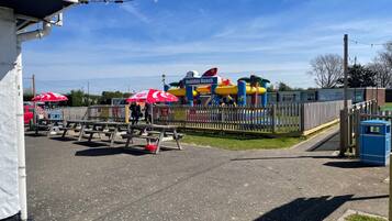 A playground with inflatable slides and a sign that reads "Holiday Beach."