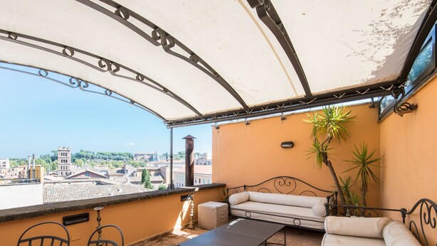 A terrace with a sofa, chairs, and a table. - Santa Cecilia View by Interhome (Rome: Historical City Center)