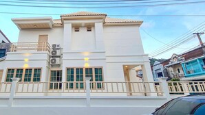 A two-story building with a balcony, air conditioning units, and a light fixture on the second floor. - 48 House - Patong (Tambon Patong)