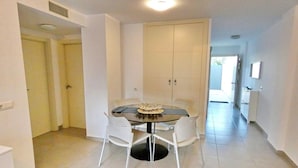 A dining area with a round table and four chairs, a large cabinet, and a ceiling vent. - El Grullo, with community pool. (Conil de la Fra.)