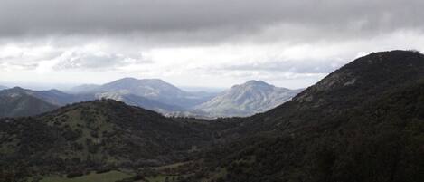 A mountainous landscape with rolling hills and a valley.