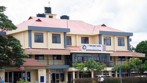 A two-story building with a sign for the Diplomat Hotel. - Arusha Diplomat Hotel (Arusha)