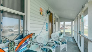 A covered porch with wicker furniture and a view of the street. - 2 Mi to Redfish Bay: Aransas Pass Home w/ Fire Pit (Aransas Pass)