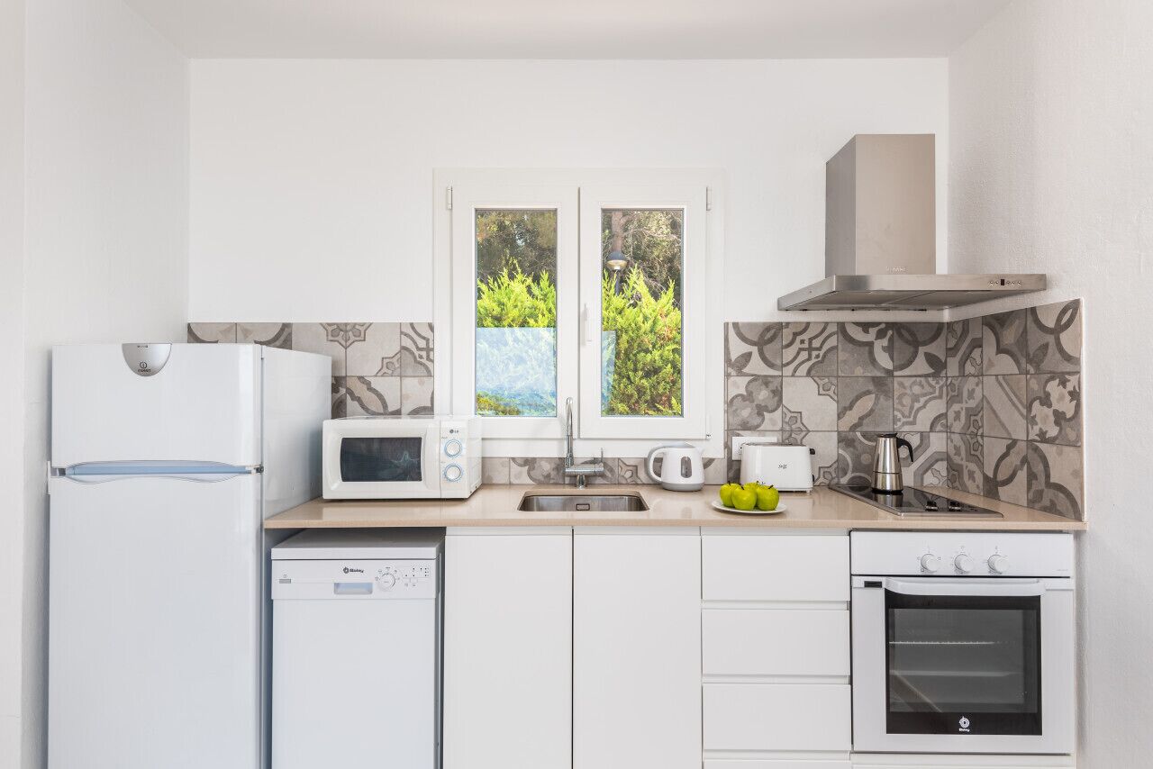 A modern kitchen with a dishwasher, microwave, stove, and oven.