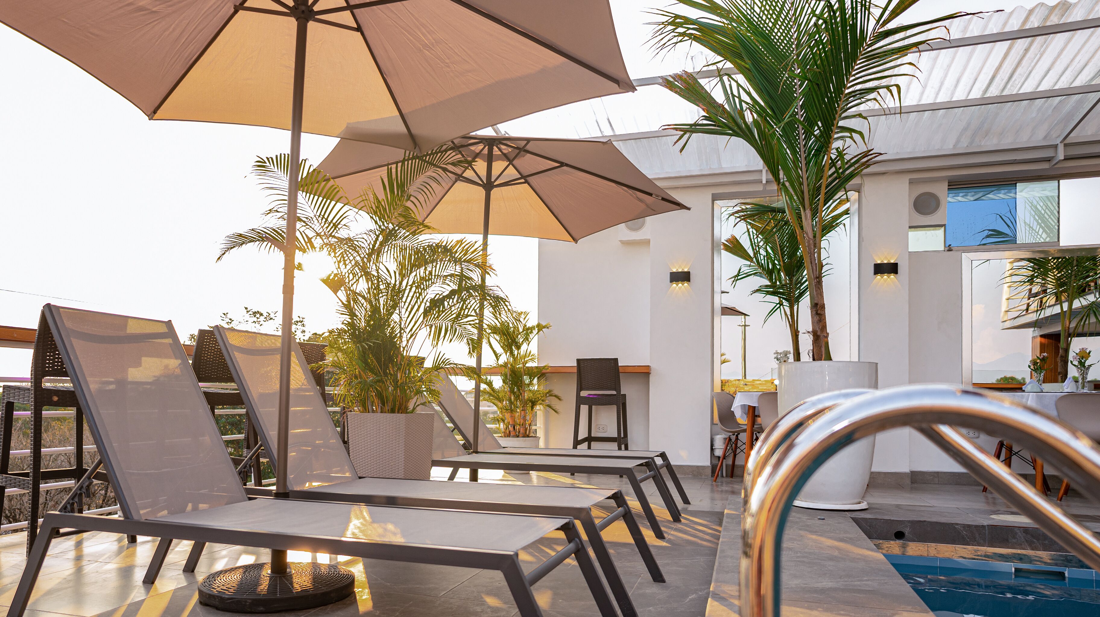 Outdoor pool, open 10:00 AM to 10:00 PM, pool umbrellas