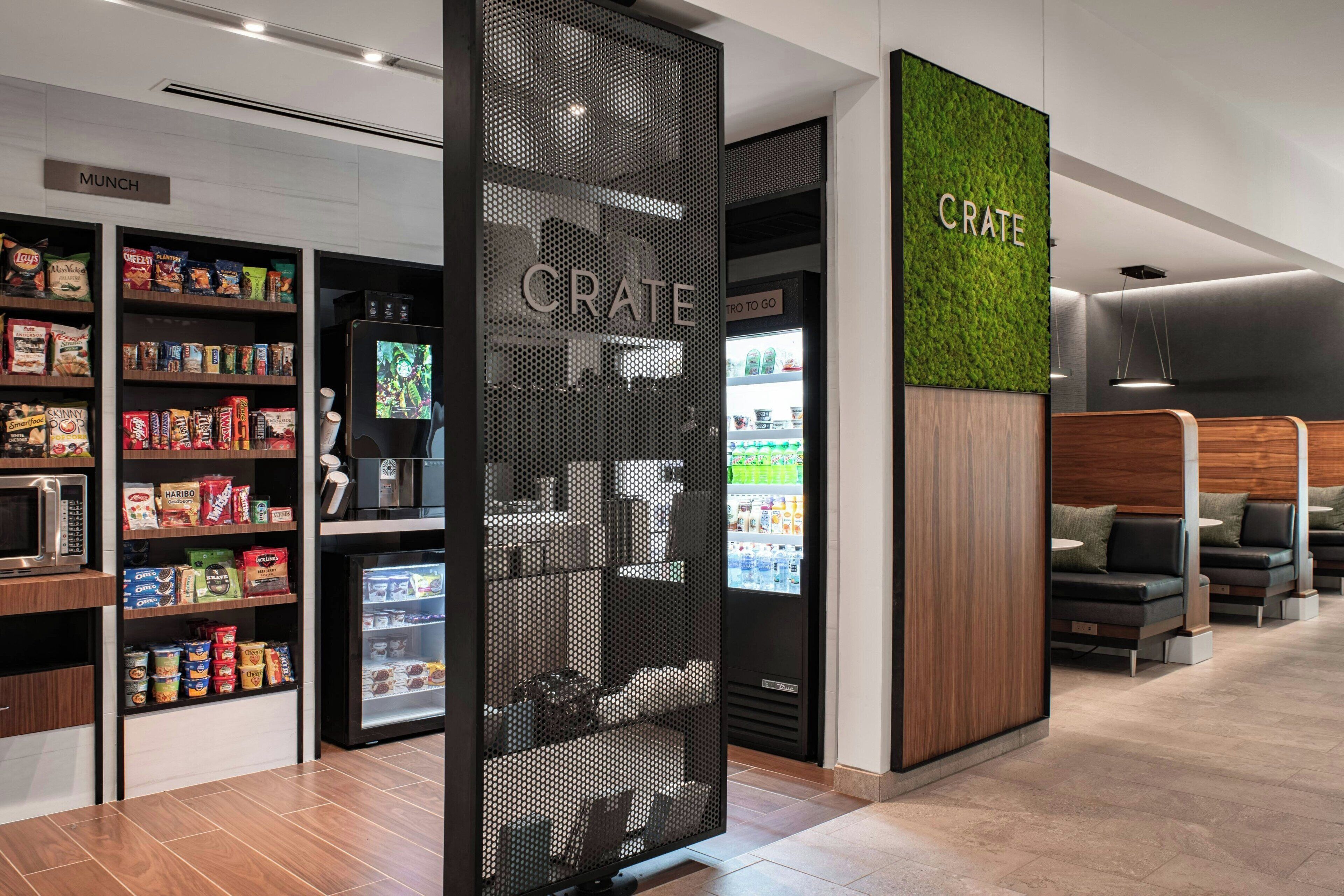 A modern snack bar with shelves of snacks and a refrigerated display.
