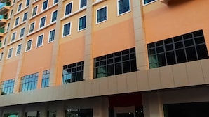 A multi-story hotel with a modern design, featuring numerous windows and balconies. - Hotel Kapalai (Semporna)