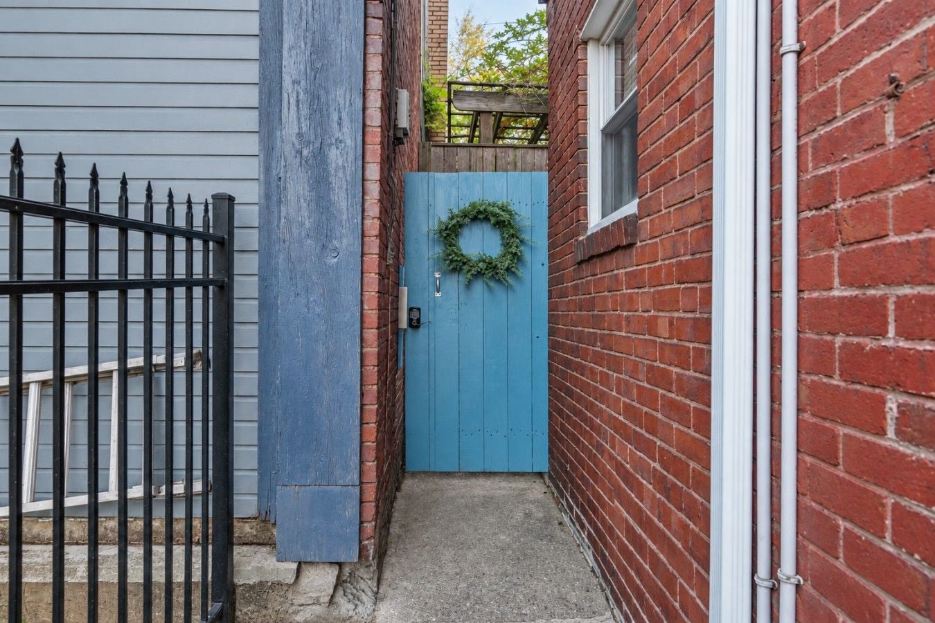 Follow the side walkway to the gated outdoor space, perfect for enjoying a little fresh air.