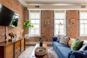 Relax in this inviting space with a flat-screen TV, comfortable sofa, and a cozy coffee table.