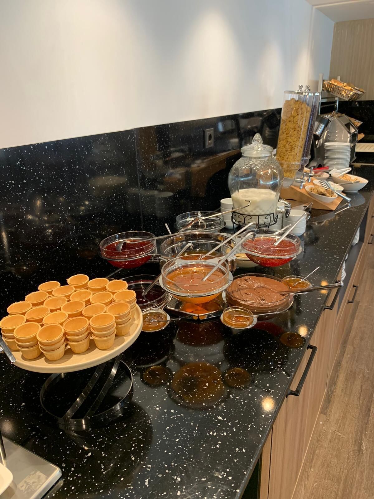 A buffet setup with various food items and condiments.