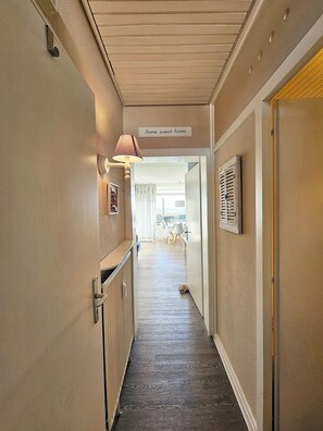 Enter a cozy space with a warm welcome sign, leading to a room with a window offering a view of the outdoors.