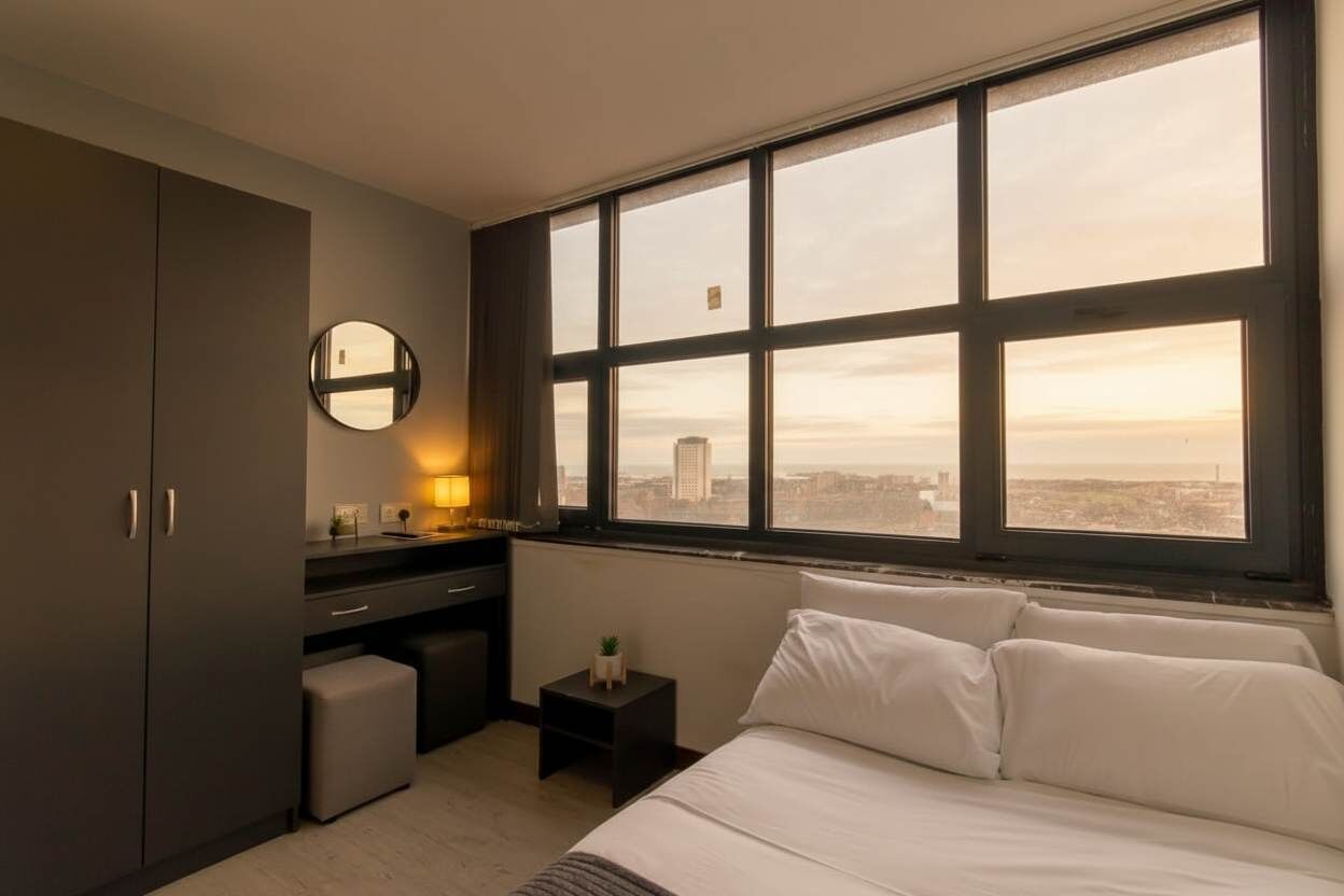 Desk, iron/ironing board, bed sheets