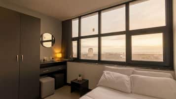 Desk, iron/ironing board, bed sheets