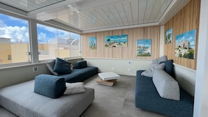 A modern living room with two sofas, a coffee table, and artwork on the walls.