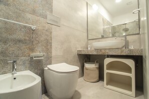 A modern bathroom with a sink, toilet, and mirror. - azzurra guest house  (Lampedusa)