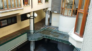 A multi-level building with a central staircase, metal railings, and a tiled floor. - Central Apartment for 4 with Parking in Jaca's Main Street (Jaca)