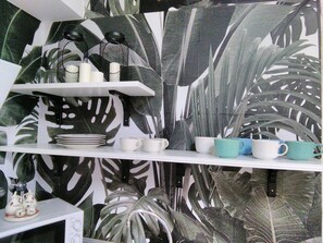 Relax in a serene space with a tropical twist, featuring a natural-inspired design and a cozy atmosphere.