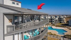 A multi-story building with balconies, a swimming pool, and a clear sky. - Shipwatch 1411 - Point Unit (North Topsail Beach)