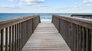 A wooden pier leading to the beach with a clear view of the ocean and sky. - Anchor of Santorini - 5 Bedroom Oceanfront Townhouse Sleeps 15 (Surf City)