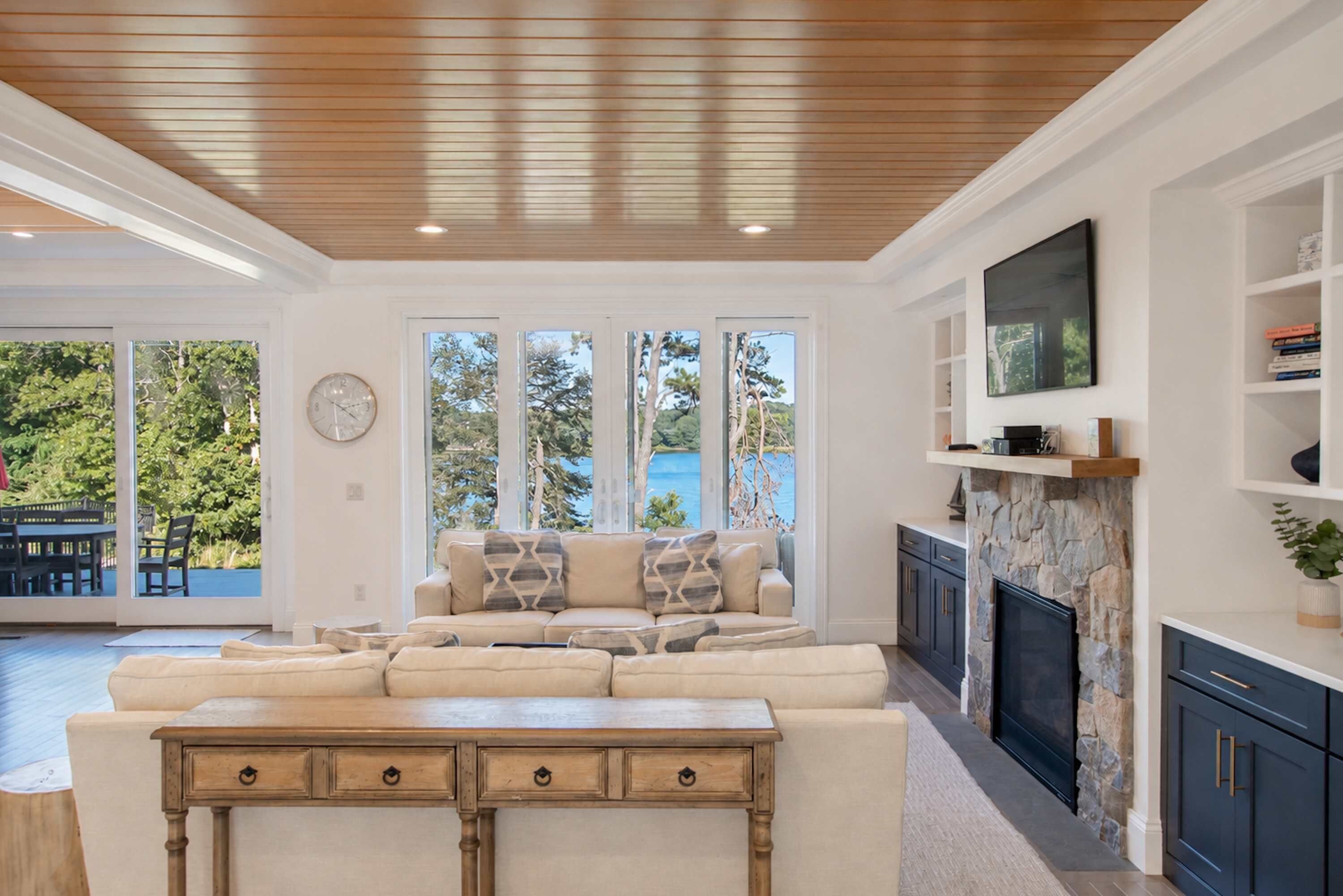 A living room with a sofa, a coffee table, a fireplace, and a television.