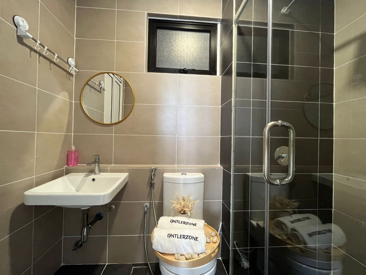 A bathroom with a sink, toilet, and shower.