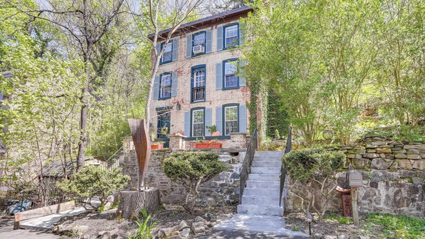 A multi-story building with a stone staircase leading to the entrance. - Lambertville Retreat - Walk to Shopping & Dining! (Lambertville)