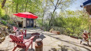 A patio with red Adirondack chairs, a red umbrella, and a fire pit. - Lambertville Retreat - Walk to Shopping & Dining! (Lambertville)