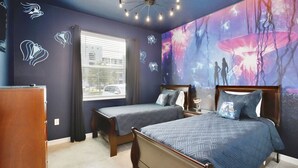 A bedroom with two beds, a nightstand, a dresser, and a large mural on the wall. - 3121-108 Resort Lake View Disney Universal Orlando (Kissimmee)