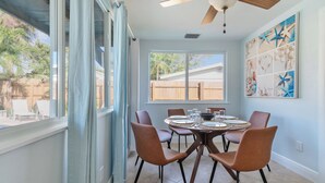 A dining area with a round table, six chairs, and a ceiling fan. - Pompano Oasis w/ Heated Pool 8 mins to the Beach! (Pompano Beach)