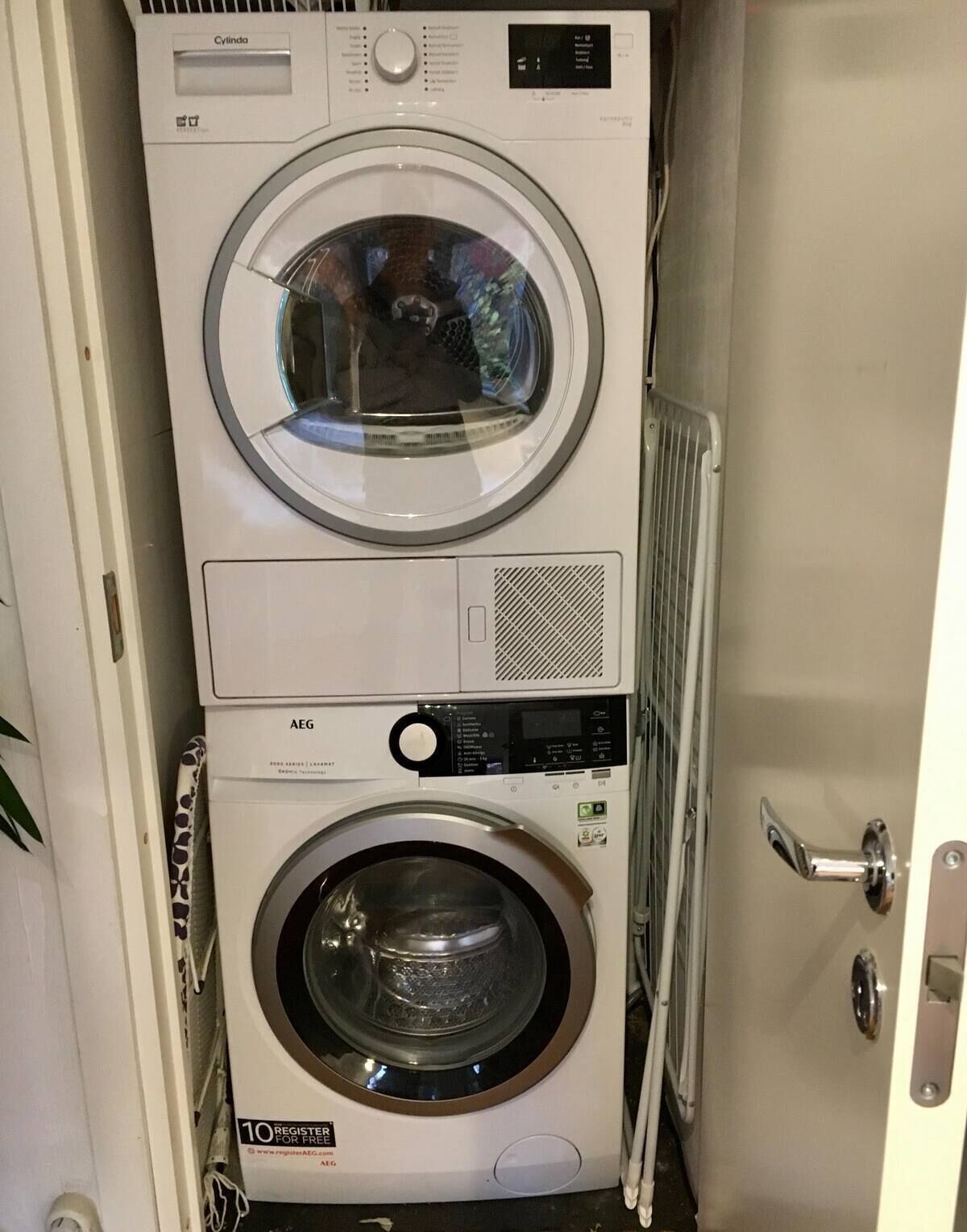 A stacked washer and dryer unit in a laundry room.