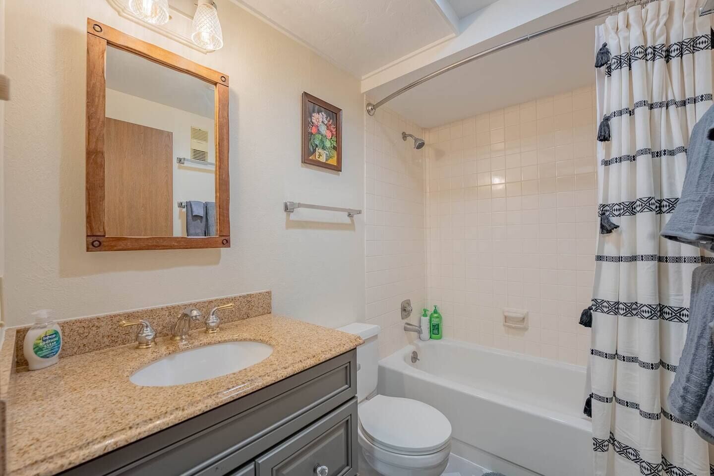 Ein Badezimmer mit Waschbecken, Toilette, Badewanne und Duschvorhang.